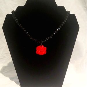 Beautiful beaded necklace with a red rose